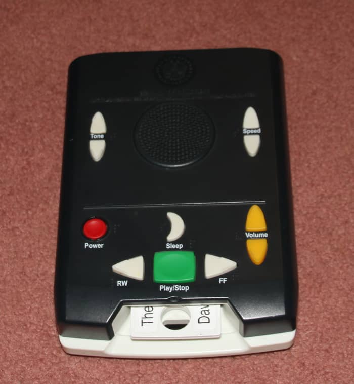 This talking book player plays books recorded on special cartridges. This device allows people to listen to books rather than use their reduced vision to read them.