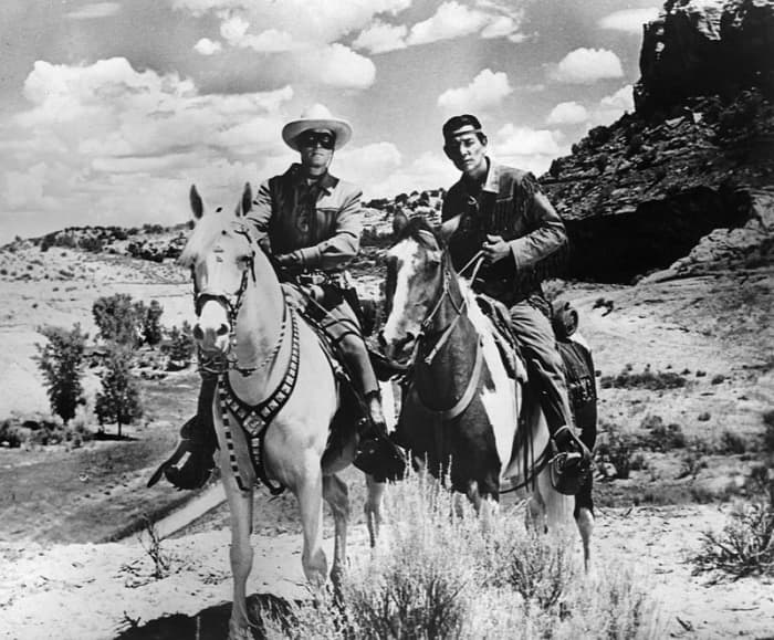 From left, Clayton Moore as the Lone Ranger on Trigger left, and Jay Silverhills as Tonto (Harold Preston Smith) his horse Scout.
