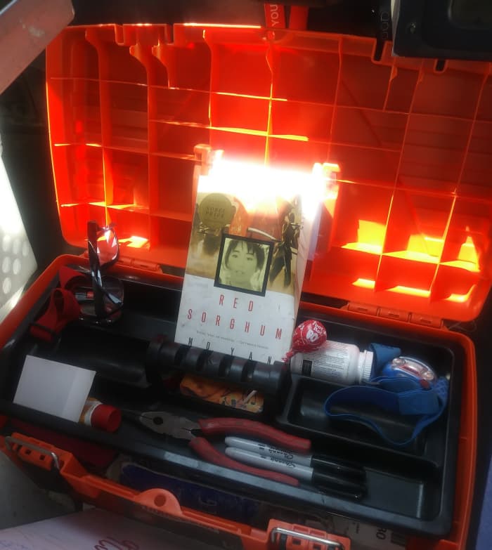 Mo Yan´s "Red Sorghum," as seen in Mel Carriere´s bright orange Homer toolbox, along with the needle nose pliers, cortisone, ibuprofen and tootsie pops he needs to ease the Sisyphean load of his postal penance.