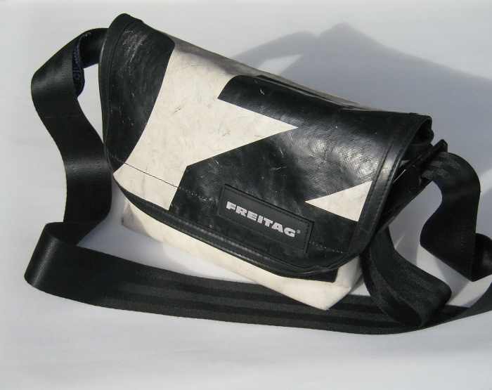 messenger bag made from old truck tarp and the shoulder strap is made from a seatbelt.