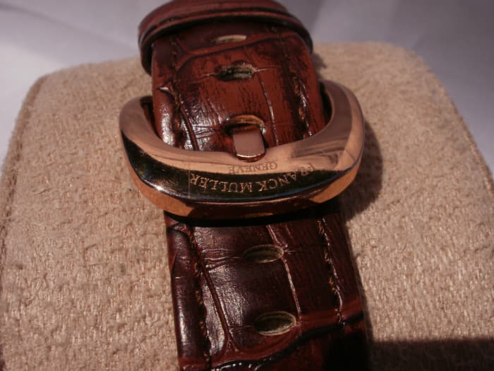Note the faded,unnatural tone to the leather. The buckle is impressive but engraved with bogus branding information.