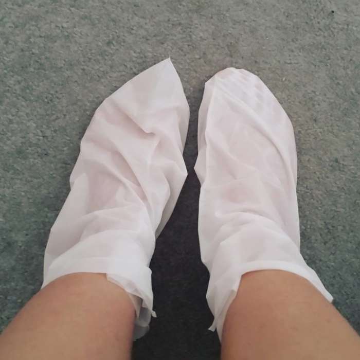 A picture of the Derma V10 Tea Tree and Peppermint Deep Moisturising Foot Pack in use.