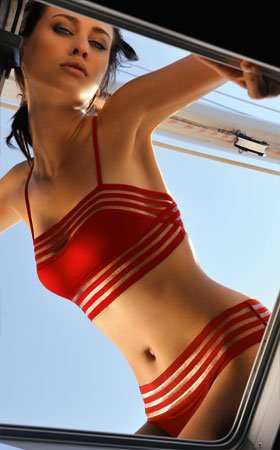 Multiple cut-out panels and a classic red color make this a bombshell of a suit.