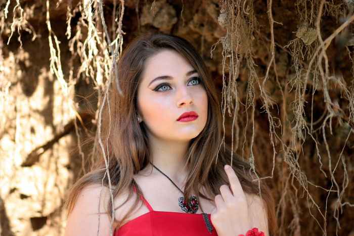 A retro-inspired makeup look with red lipstick.