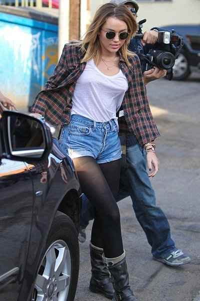 Miley Cyrus not wearing a bra while being mobbed by the paparazzi.