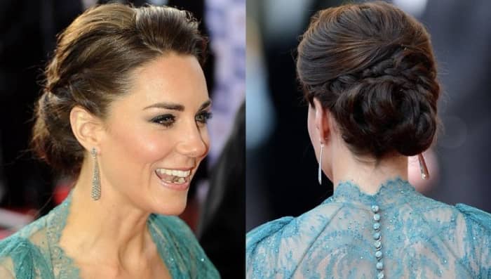Kate ties her hair in a lovely Chignon styled bun. The sides of her neck are graced by royal looking tear-shaped silver earrings. Scouse brows, mascara, hint of shimmery shadow and nude lip color give her a very natural look.