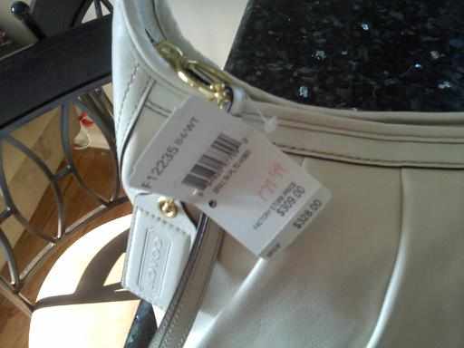 REAL Coach sales tag. Notice how the tag is looped through the hardware.