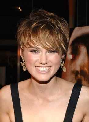 A beautiful, layered short cut with not too much volume is perfect with her face.