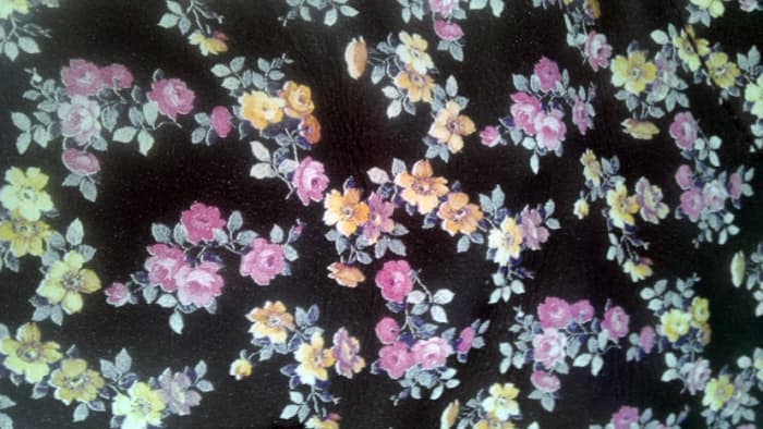 The lovely Mini Tydee pattern of tiny yellow, pale pink, and lavender flowers on black leather.