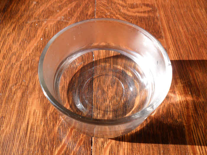 To make your hair gel, start by pouring warm water into a container