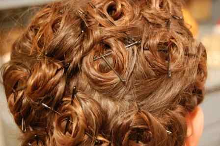 Hair should look like this in the end. Crisscrossing bobby pins over curls ensures a secure hold.