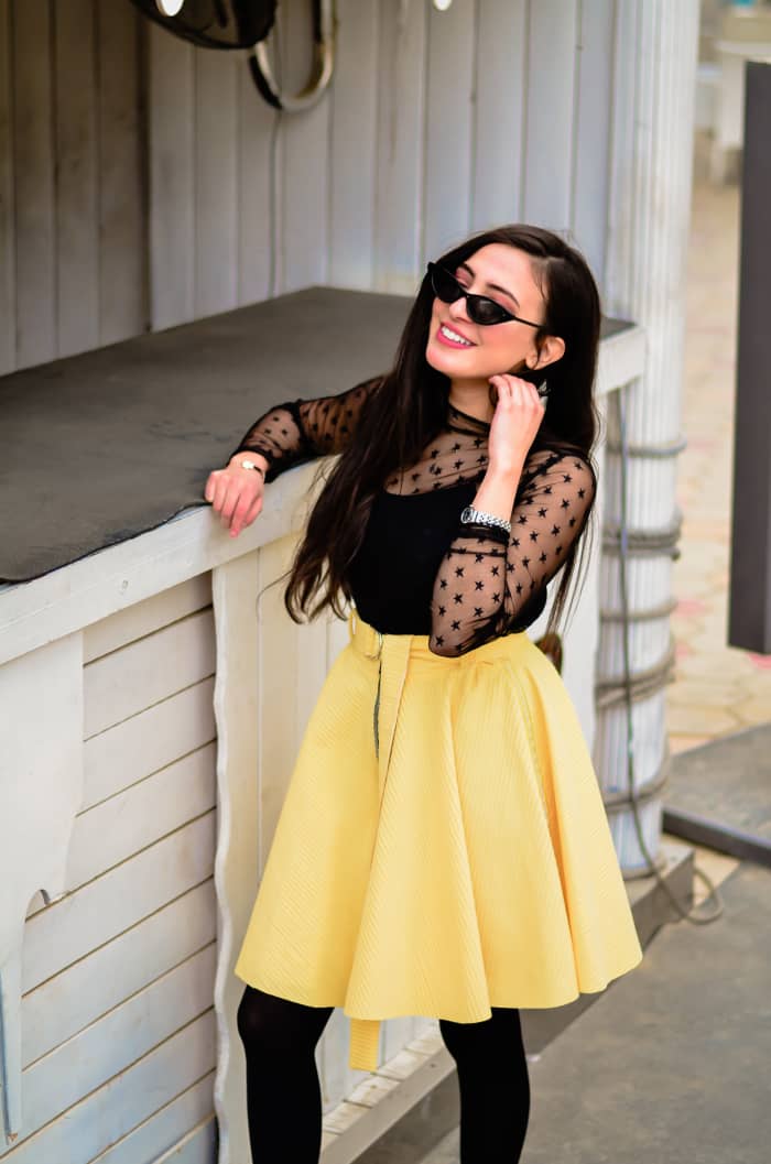 A skater skirt can be dressed up for a more casual wedding with a feminine chiffon top.
