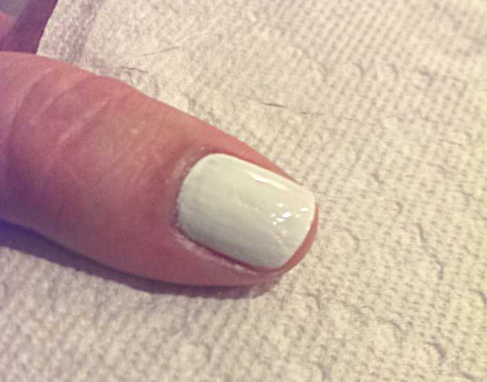 White base coat painted and cuticles clean of any polish.