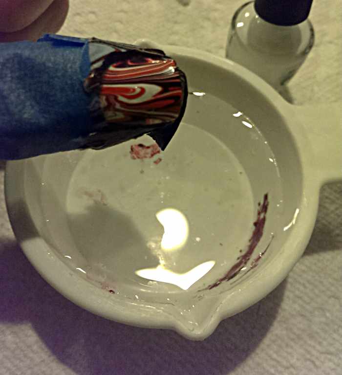 Take your nail out of the water.