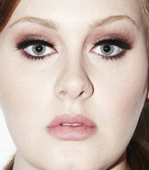 Dark shadow will help make large eyes look smaller, as it does for Adele.
