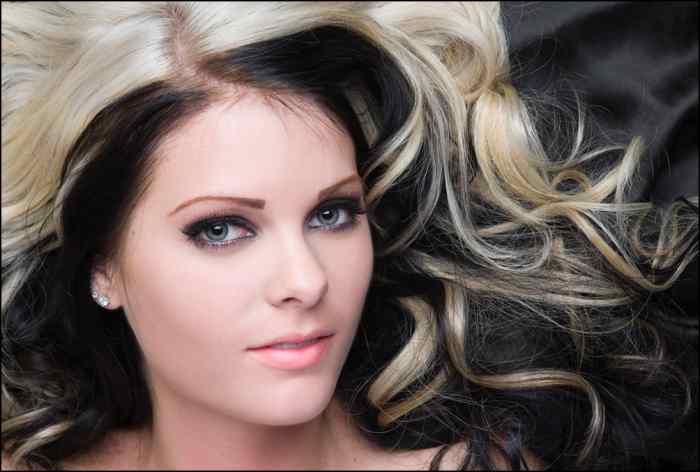 Blonde hair with black under-layers.