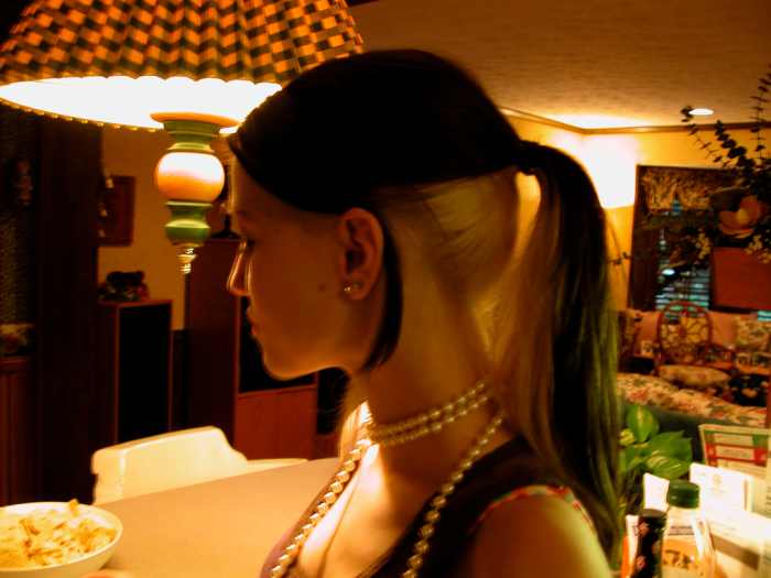 Black hair with blonde under-layers in a ponytail.