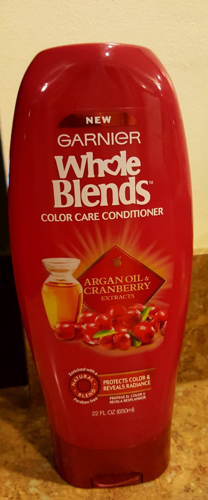 A bottle of Garnier Whole Blends Color Care Conditioner Argan Oil and Cranberry Extracts, which gave me great results.