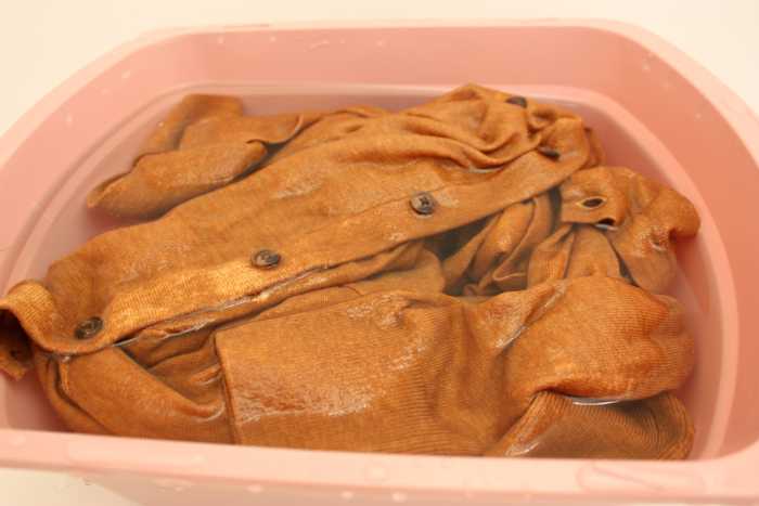 Heat (via water or air) is what makes certain fabric fibers shrink.