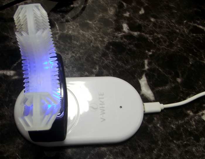 V-White 360° Electric Toothbrush as it is being charged