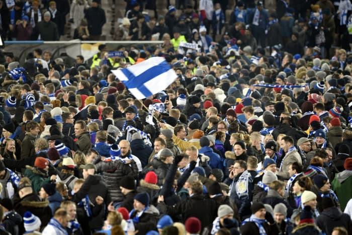Finnish fans and players celebrate following the end of a Euro 2020 qualifying match in Helsinki, Finland, on Nov. 15, 2019. The 3-0 victory against Liechtenstein secured Finland's first-ever qualification for a major tournament.