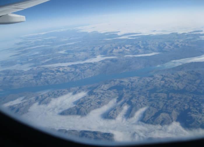 Mountains and fjords of SE tip of Greenland taken while flying 30,000 Feet above Greenland