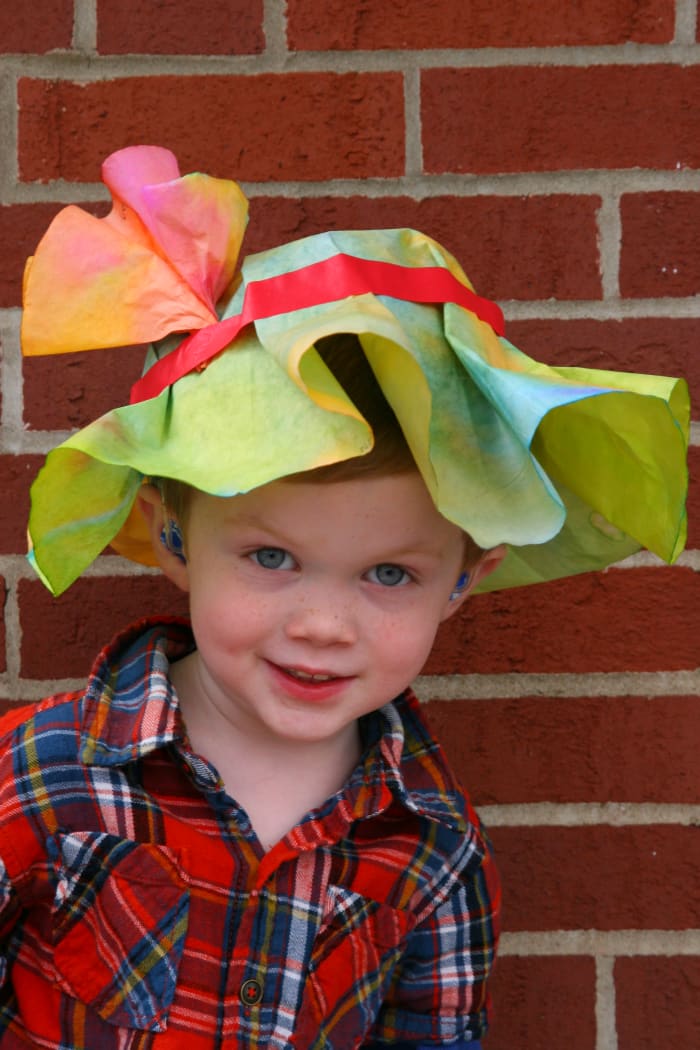 A preschool aged boy in an Easter Bonnet at a community run preschool. It is important to ask about preschool educational philosophies. Ask about how diversity, religious festivals, cultural rites, and other matters are handled in the school.