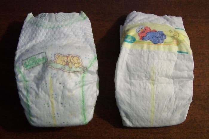 The baby Winnie-the-Pooh characters on the Huggies diapers can be seen on the left, while the Pampers feature baby Sesame Street characters on the right.