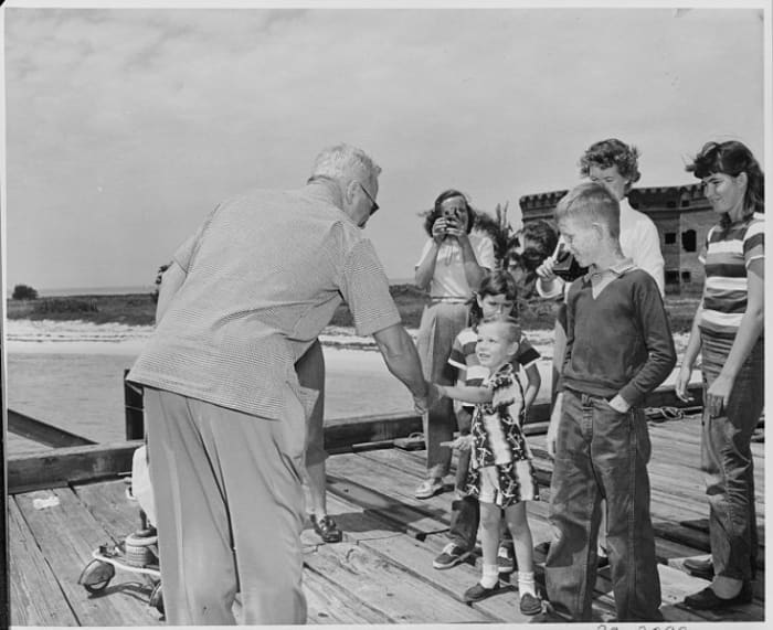 President Truman shaking hands with a child upon his arrival at the Fort Jefferson National Monument.