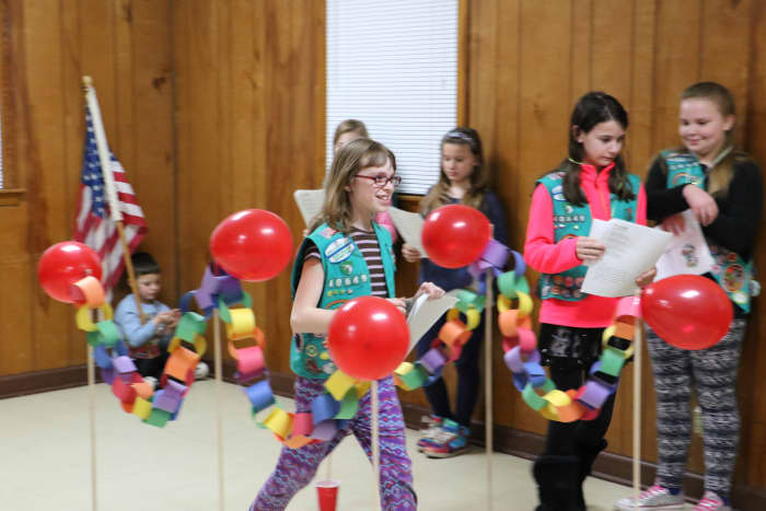 Some awards carry over when girls bridge to the next age level. Here, a troop participates in a bridging ceremony.