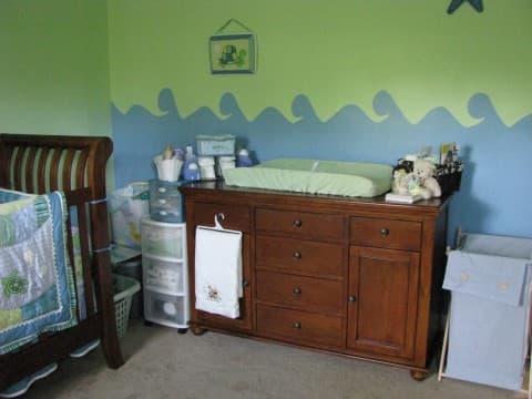Prepare the baby nursery by adding baby furniture that is practical and helps you stay organized.