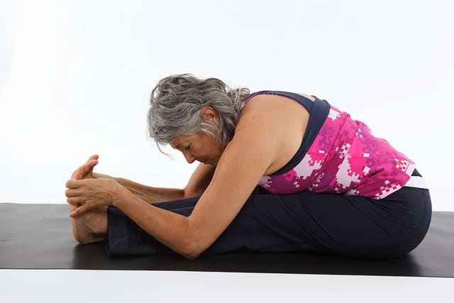 The Forward Bend: Only stretch as far forward as is comfortable for you. Everyone's flexibility is different.