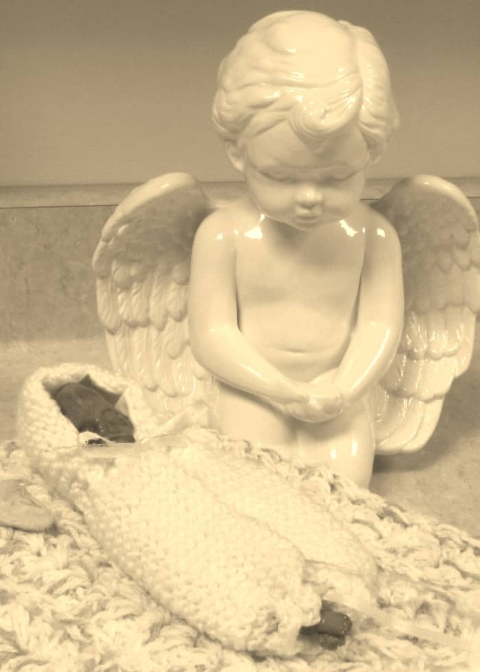 Jenni was 5 oz and 8.5 inches long. They dressed her in a pink sleep sack and wrapped her in a pink crocheted blanket.