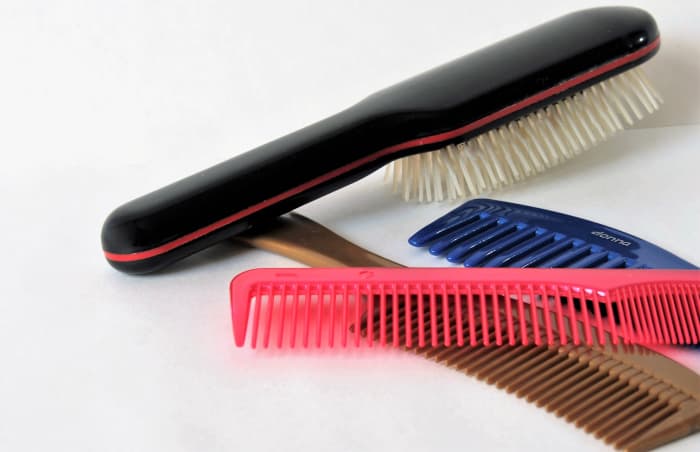 You might want to throw out your hairbrushes and buy new ones. In the future, never share brushes between family members.