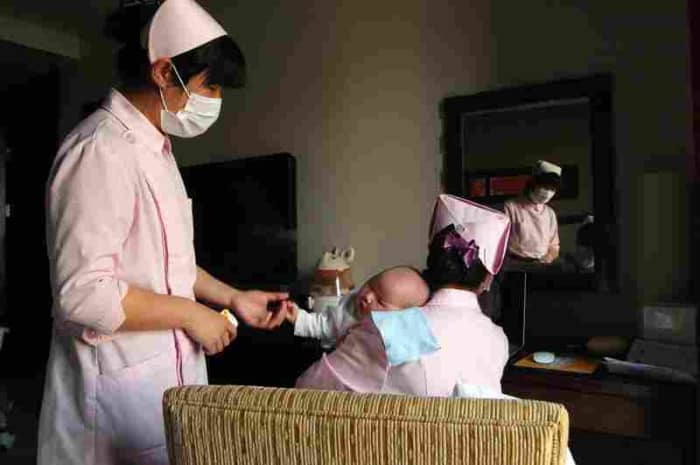 Nurses in a confinement centre catering for new mothers as they sit the month, over 120 staff care for them and their new borns.