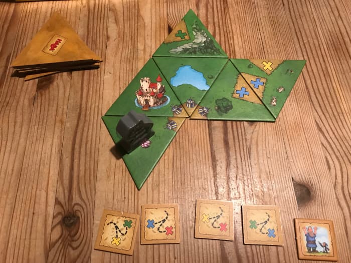 You must place tiles so that the edges match the previously played tiles. For example, here you can see the tournament illustrations (the small tents) matching in the center and the blue quest markers matching to the right.