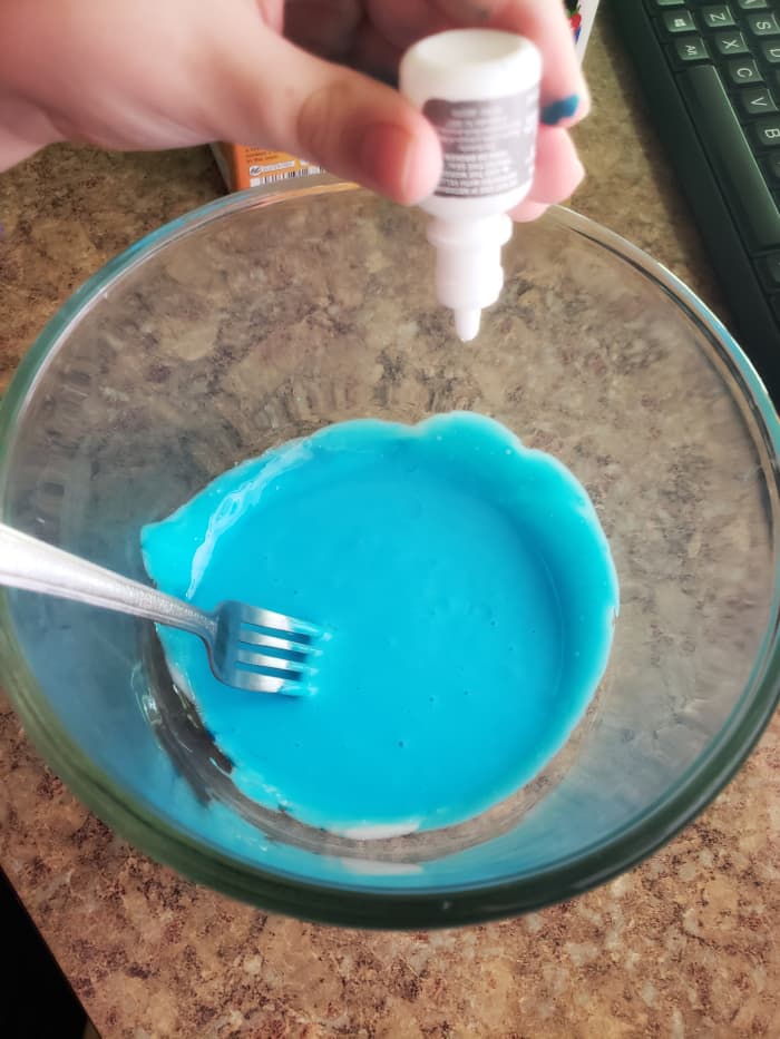 Slowly stir in a few squeezes of the eye drops. Begin kneading the slime, adding in more drops until you get a smooth, Silly Putty consistency.