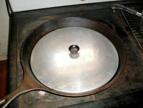 This unusually large cast iron skillet, being 14" in diameter, is big enough to do stir-fry for a medium-size family, or cook several steaks at once.