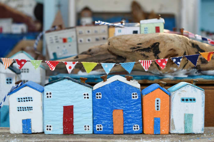 Children can use their imaginations and exercise problem-solving skills by figuring out how to construct a cardboard town.