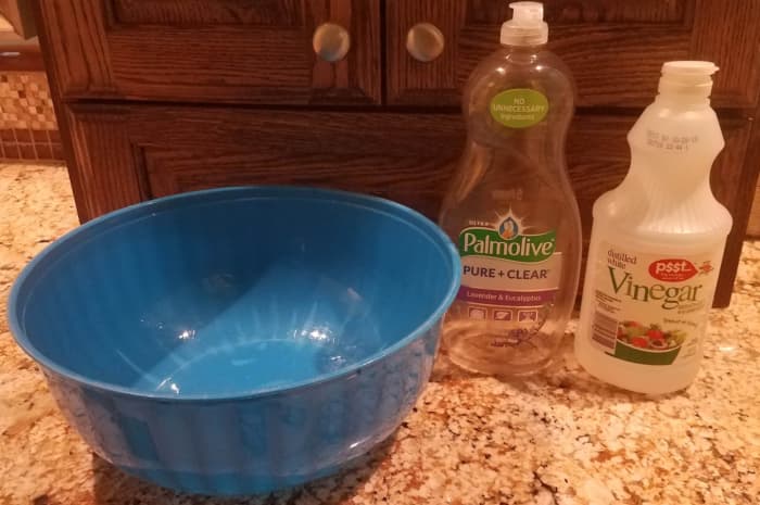 Keep a large bowl, dish soap, and white vinegar in your bathroom to quickly take care of peed on clothing.