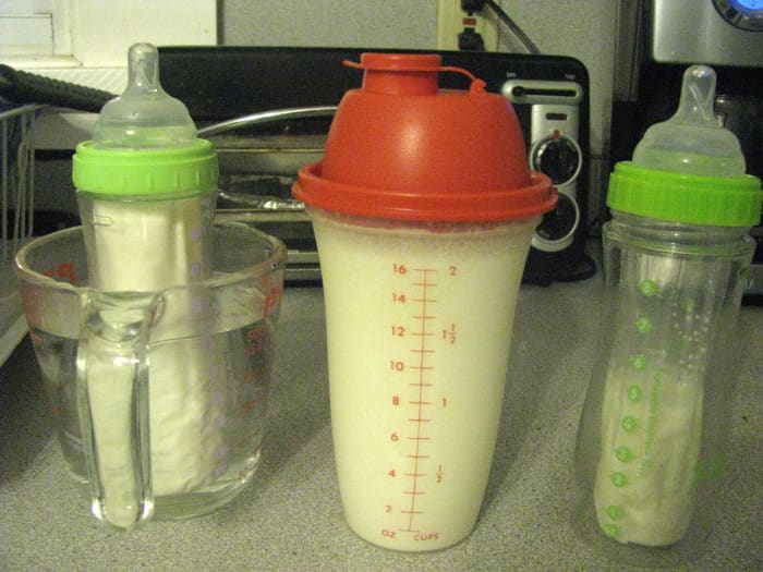 Use a Tupperware shaker mixer to properly mix powdered formula, and then warm the bottles using warm water in a measuring cup.
