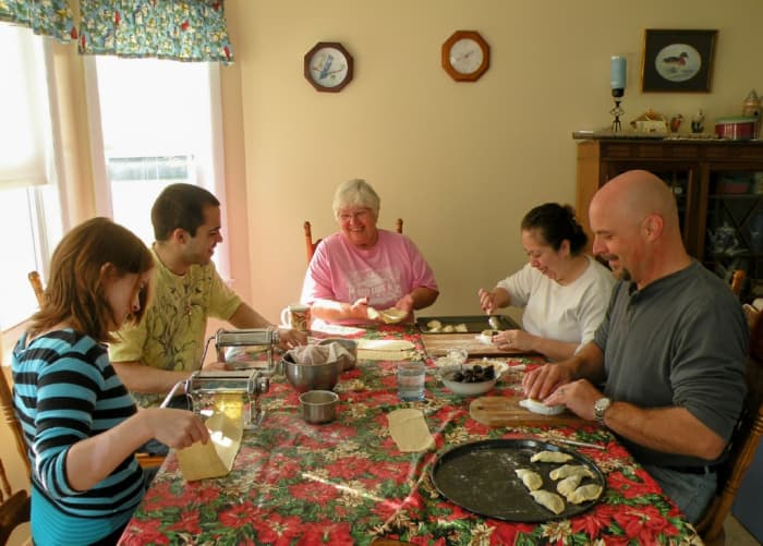 Passing on family traditions is one role of a grandmother. Here the whole family makes pirogies for Christmas Eve dinner.
