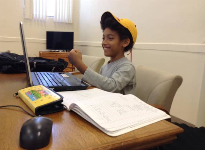 My youngest son working on his assignments online. When he's this excited about learning, why change to regular school?
