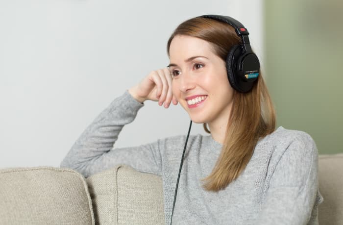 Putting on headphones and listening to your favorite audiobook is a great way to tune out the world for a while to focus on yourself.