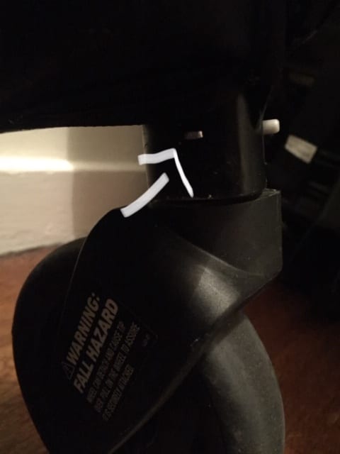 All four wheels can be taken off by pushing a button. Just look for the small silver button on every wheel.