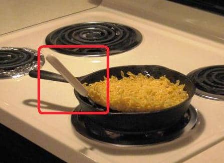 This photo shows me using a large spatula to get under the half-cooked kugel. The underside is toasty brown.