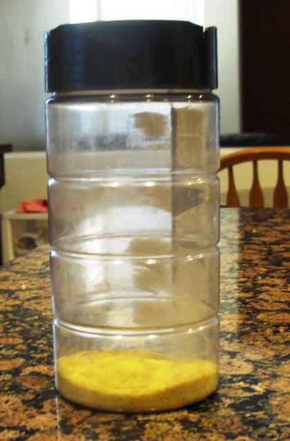 We keep an old parmesan cheese container full of cornmeal to keep the dough from sticking to the pizza stone.