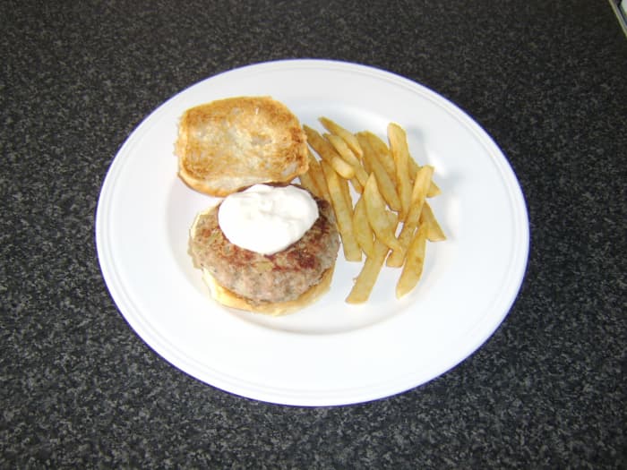 This half pound sage and onion turkey burger is served on a toasted bread roll with garlic mayo and a side of fries