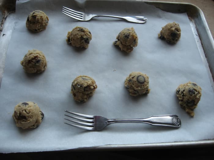 Use a parchment paper on sheetpan and place same size scooped cookie dough leaving spaces in between.