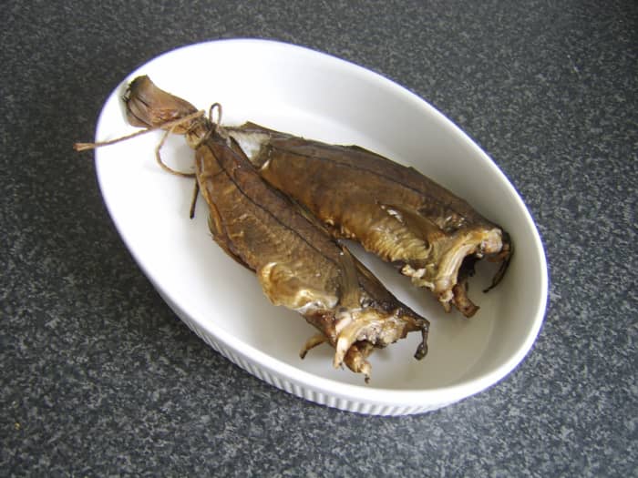 A pair of fresh from the smokehouse Arbroath smokies, still tied together by their tails, this being the way in which they are smoked